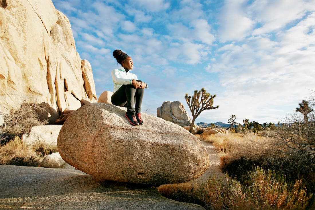 Black hiker in desert landscape, Joshua Tree National Park, California, United States