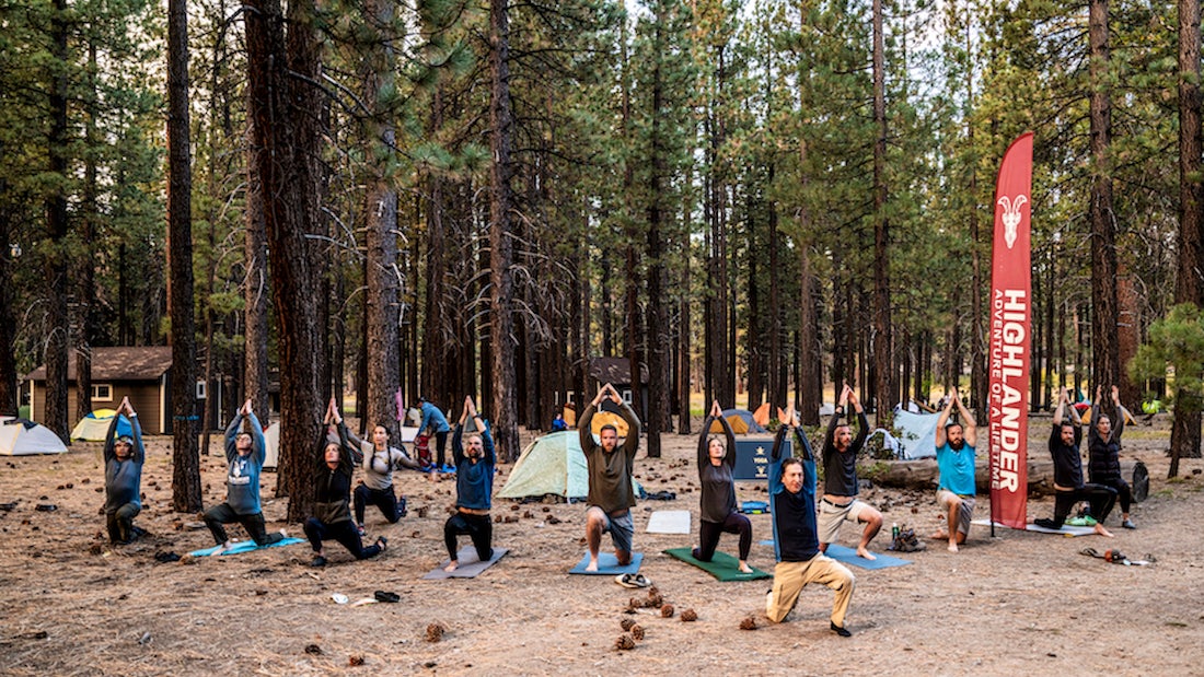 a group of hikers participating in a yoga class