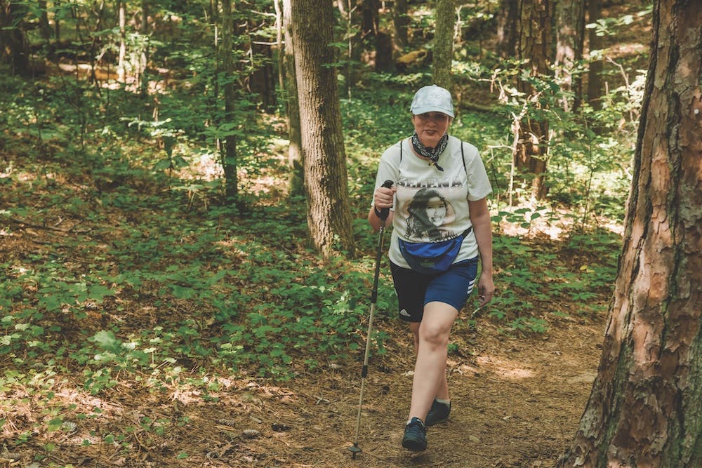 woman hiking with shirt with selena on it