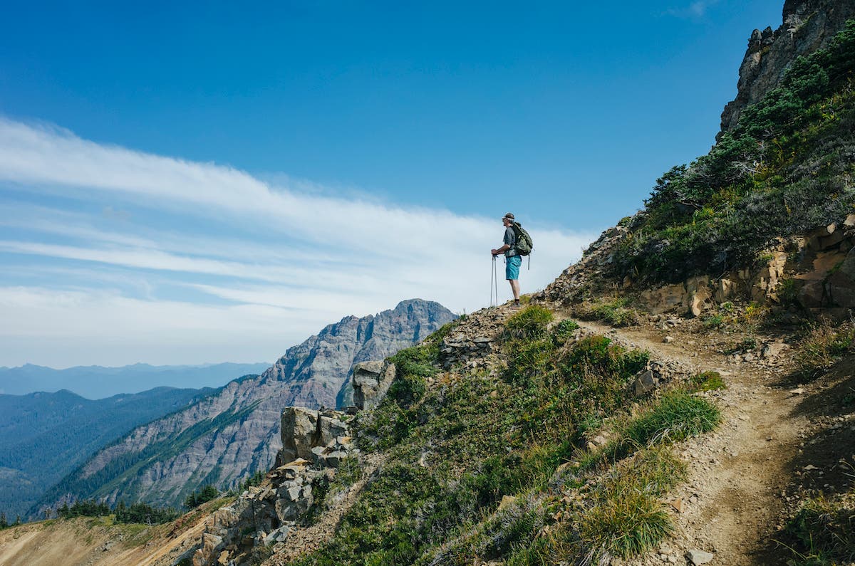 Male hiker pauses to take in view along the Pacific Crest Trail, Goat Rocks Wilderness, Gifford Pinchot National Forest, Washington