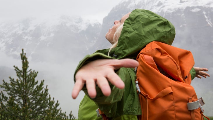 hiker holding her arms open