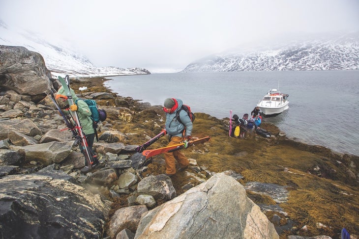 people carry gear from boat onto land