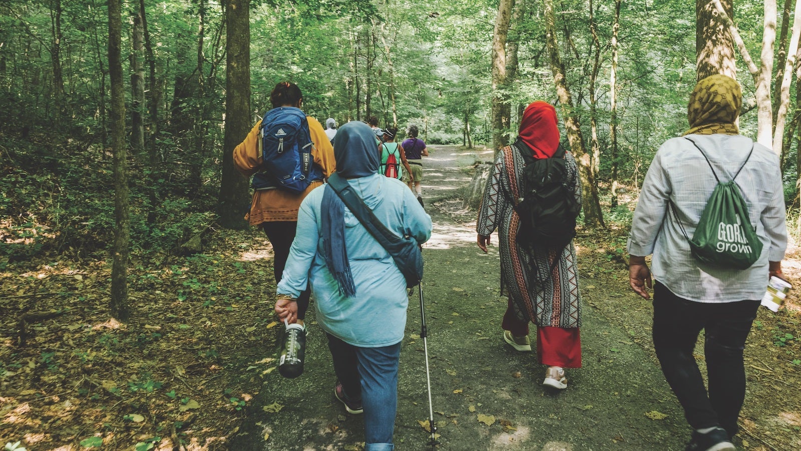 refugee women walking on trail