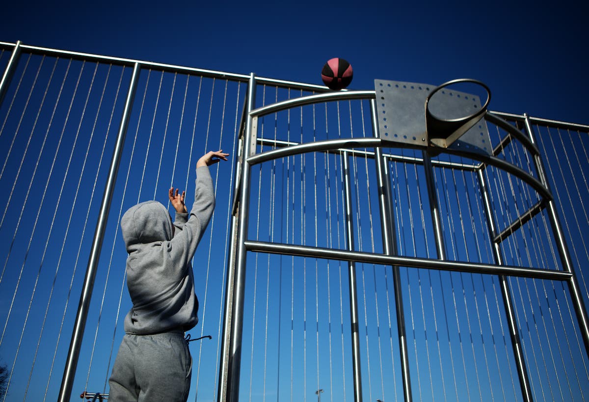 Outdoor urban basketball training session for individual female teenage girl streetball player