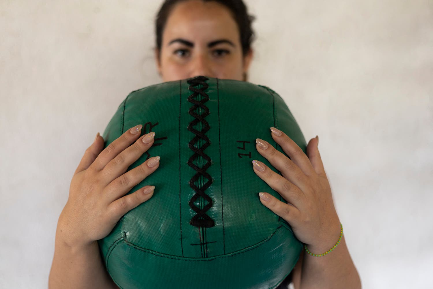 woman holding a medicine ball during functional training at the gym