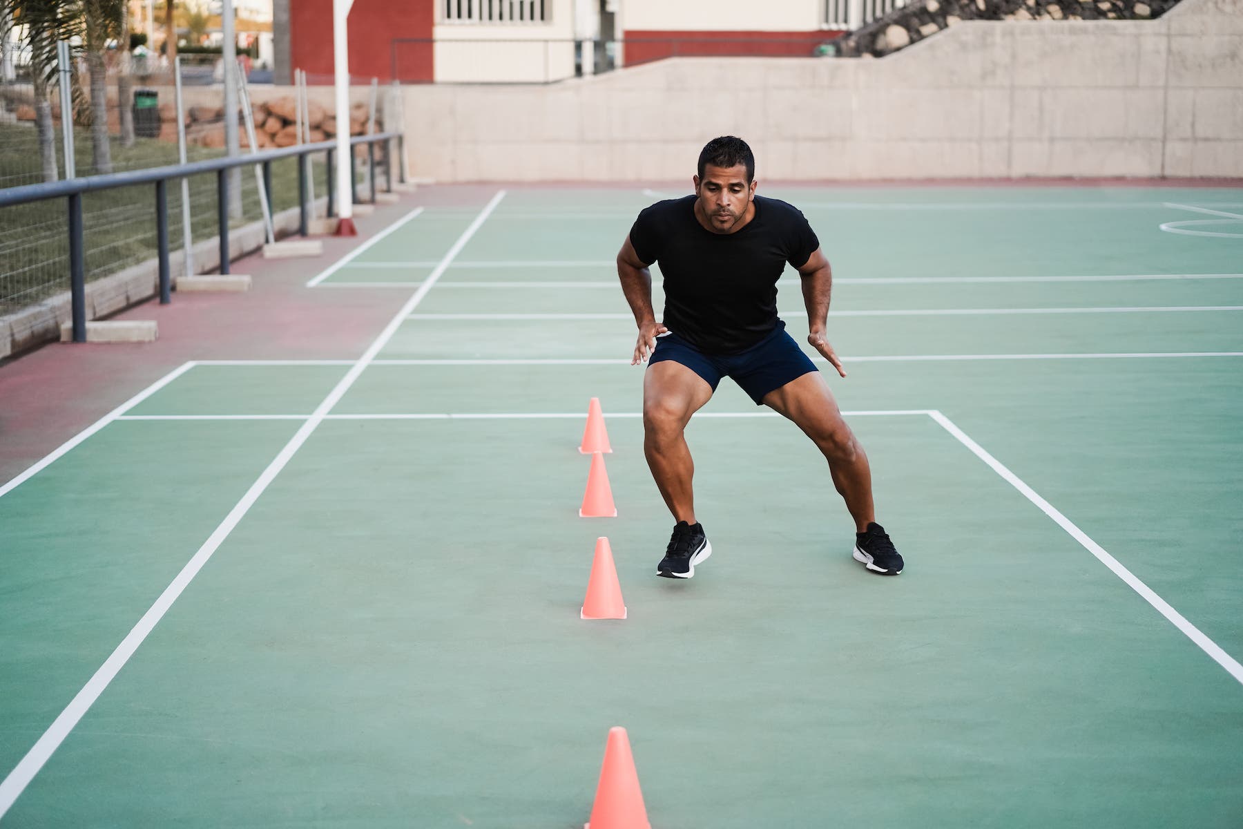 man doing speed and agility cone drills workout session outdoors