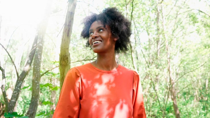 Young woman enjoying a walk in nature during spring