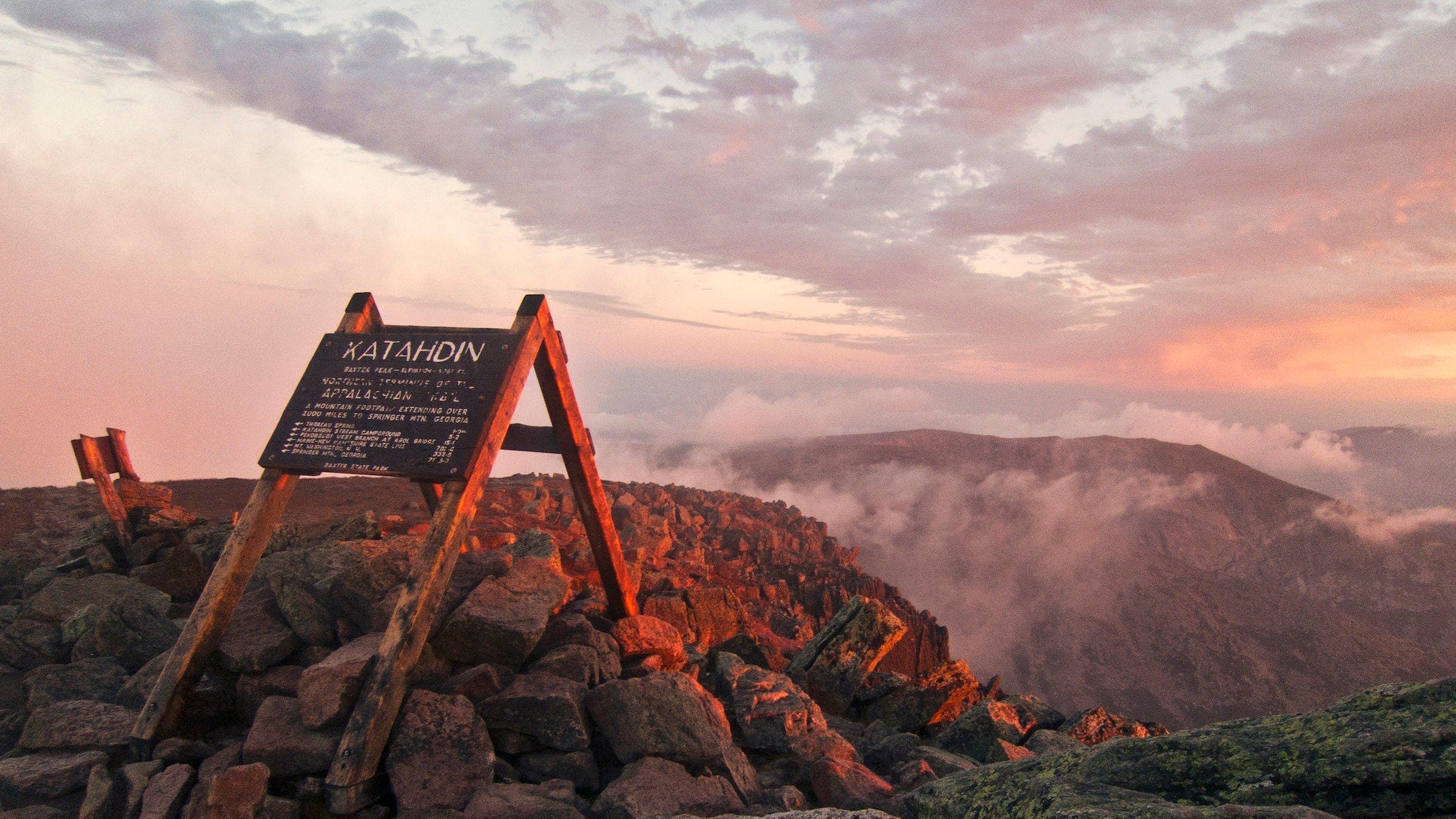 The summit sign on Maines Mount Katahdin seen at sunrise.