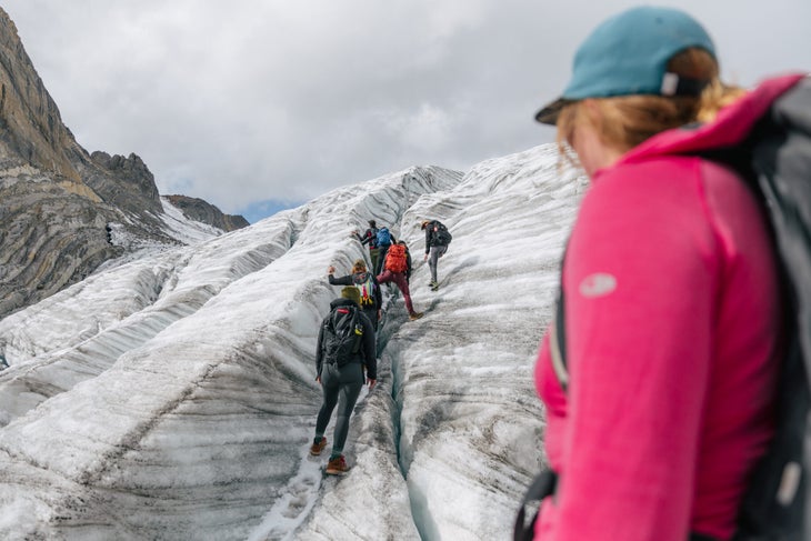 A group of hikers walking on a glacier
