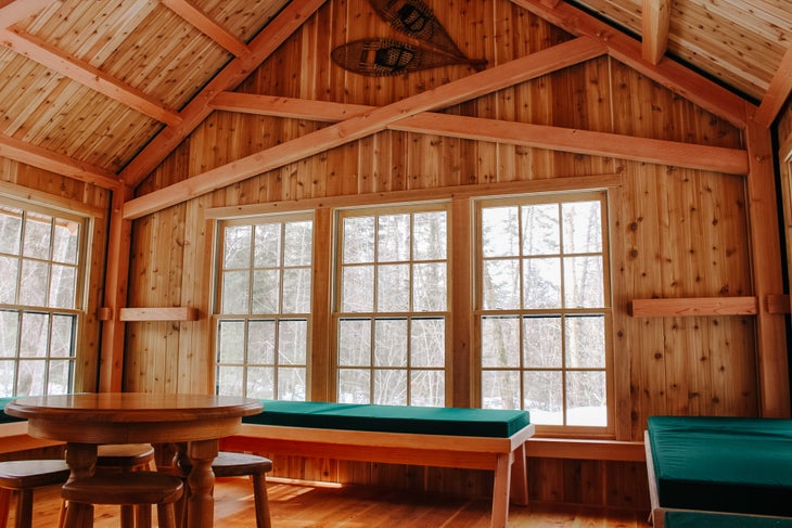 the interior of a hut with snow outside
