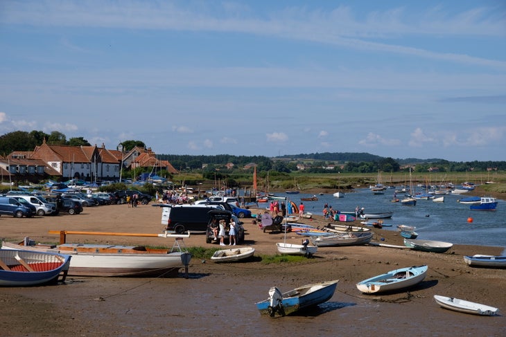 Small boats pulled up on a beach in Norfolk, England. 