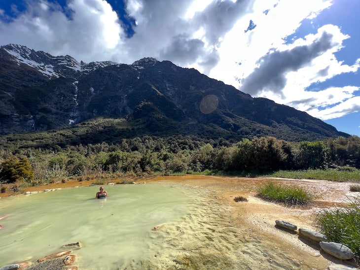 editor kristin hostetter relaxing in a hot spring after hiking