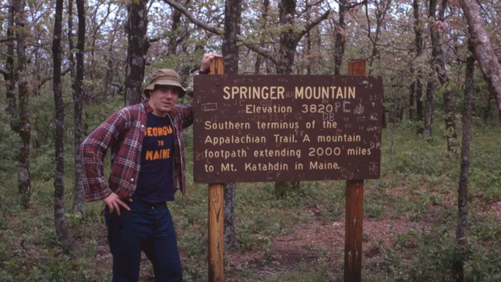 hiker at springer mountain sign