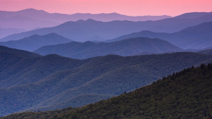 Mist rising over mountain range