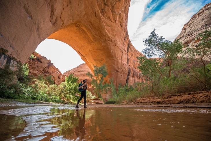 coyote gulch utah with woman standing in water