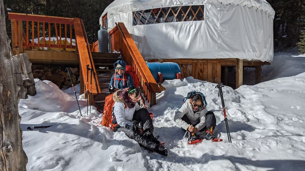 family sitting outside bull of the woods backpacking