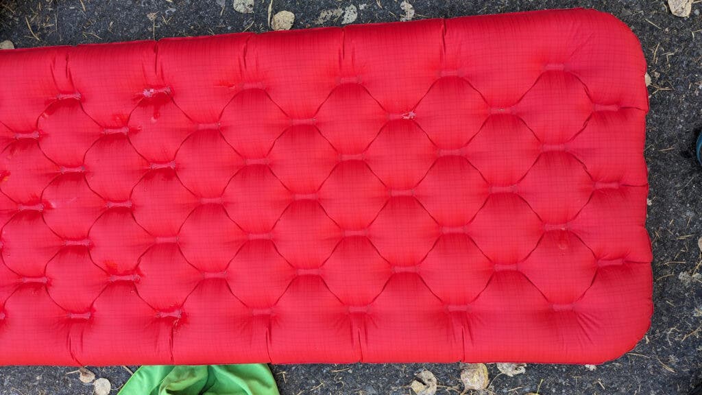 Red sleeping pad in dirt