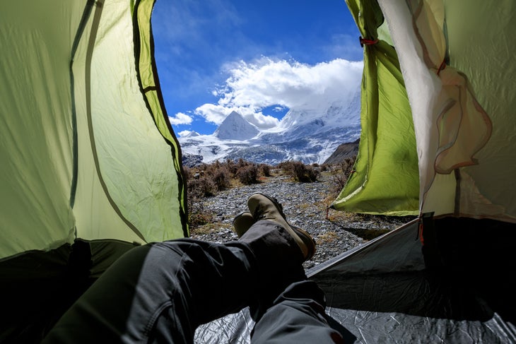 Hiker enjoy the beautiful landscape in tent