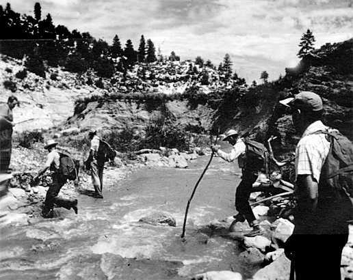 men crossing river