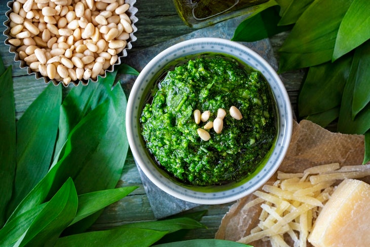 Homemade wild garlic pesto on dark wooden background