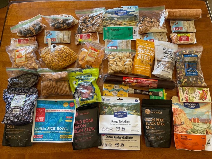 A week's worth of backpacking food laid out on a table