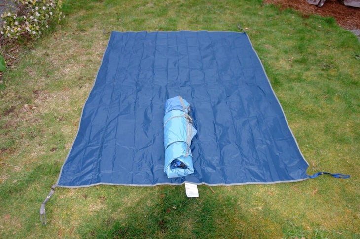 what is a tent footprint? A blue tarp lying beneath a tent 