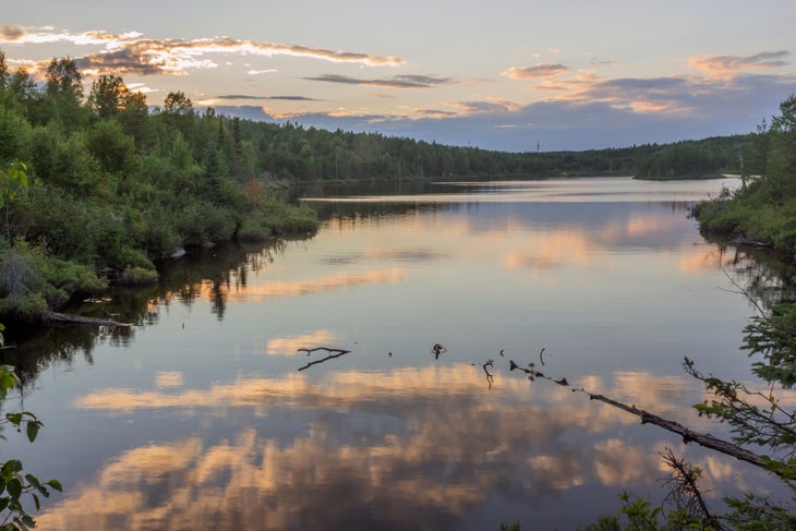 A Wide Angle Sunset Landscape of Juno Lake Reflecting a Colorful Sunset in the Boundary Waters Canoe Area Wilderness of Northern Minnesota