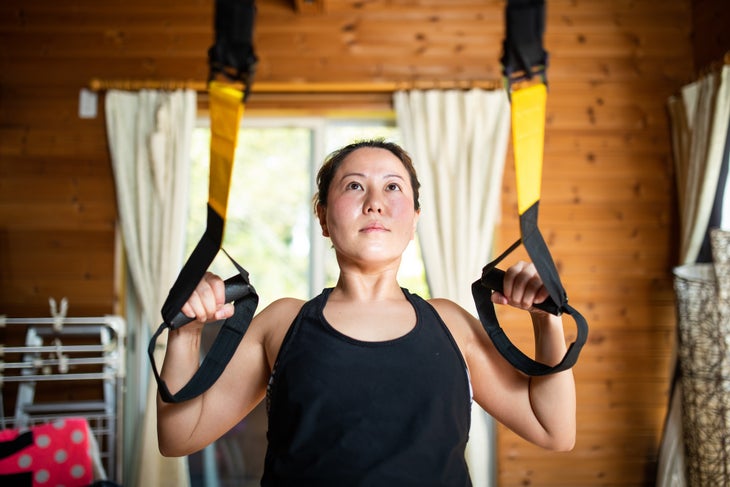 A woman exercising while staying at the home gym for hikers