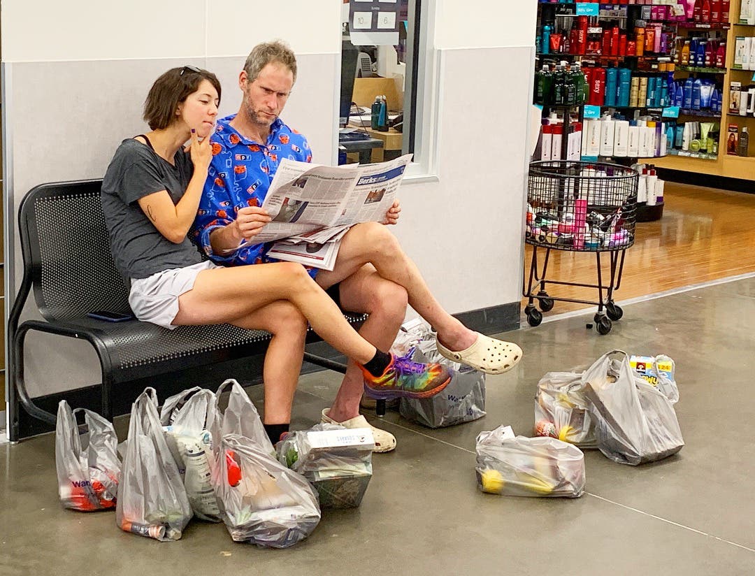 hikers reading newspaper