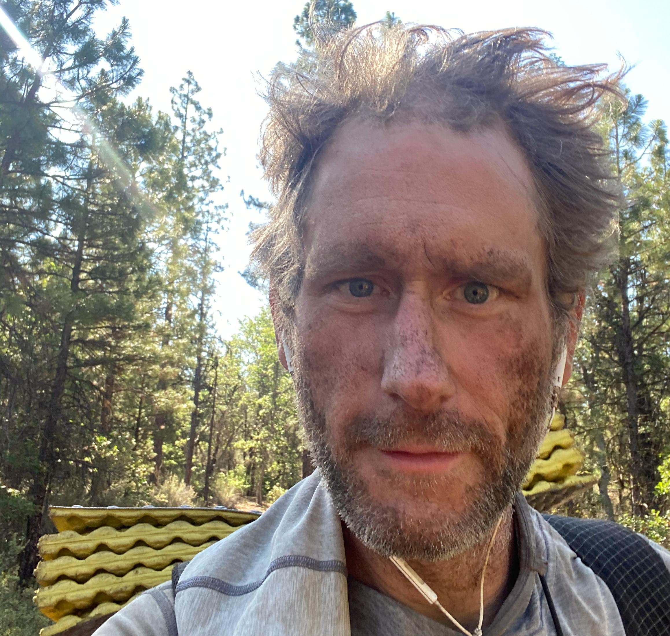 dirty-looking hiker in forest
