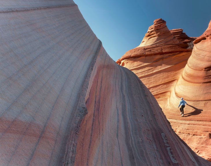 Arizona's Vermilion Cliff National Monument. USA. Hikers on trans-layer sandstone