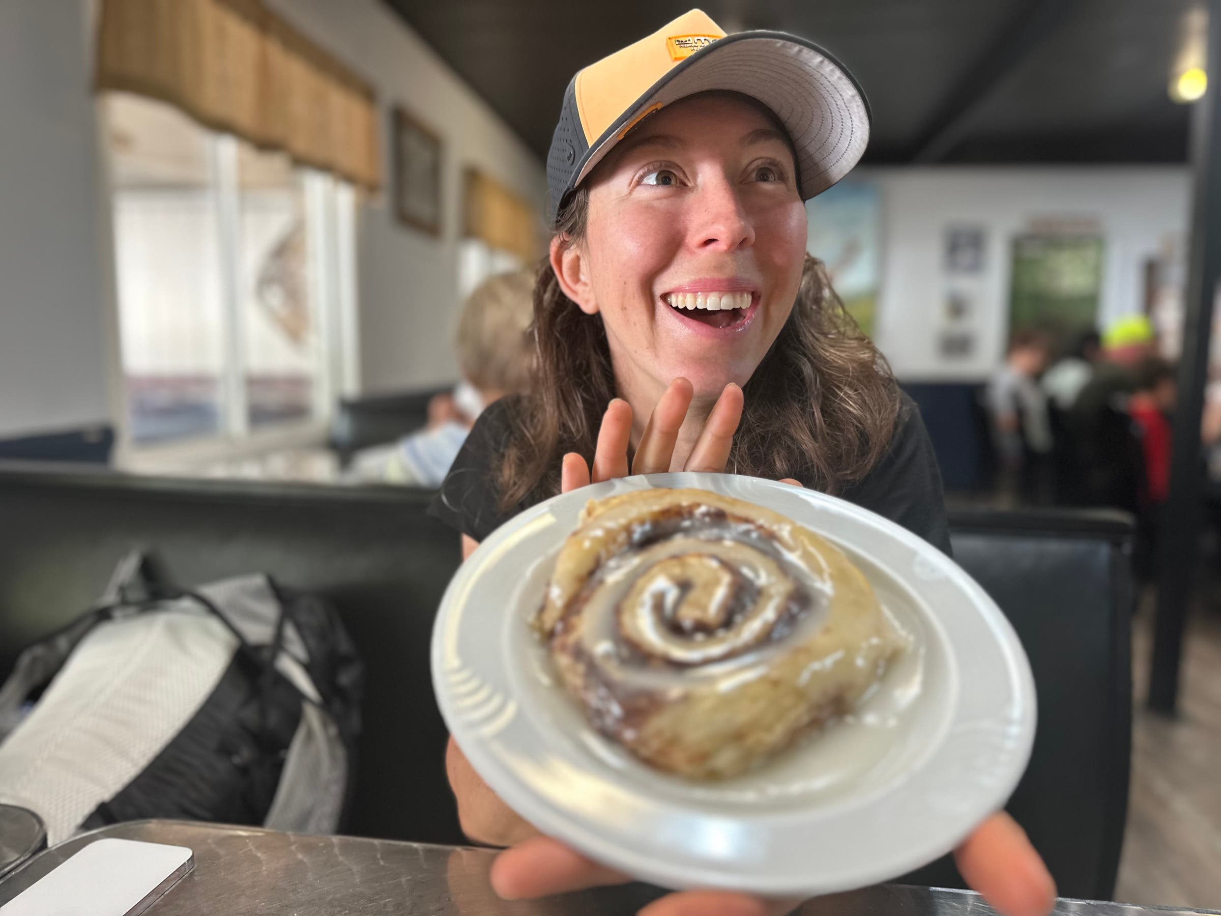 Hiker holding cinnamon roll