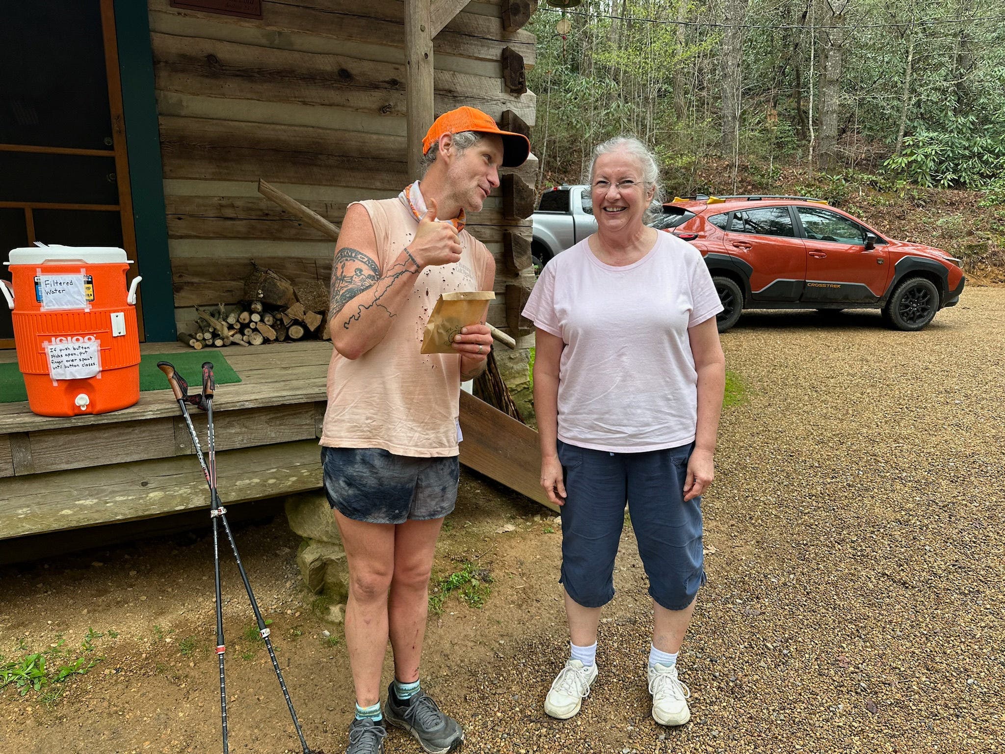 Hiker eating cookie with trail angel