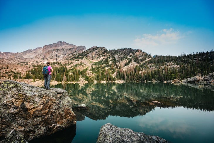 Woman Looks Out Over Haiyaha Lake in Rocky Mountain National Park