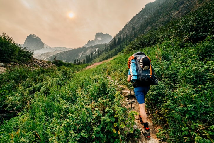 hikers on trail with wildfire smoke