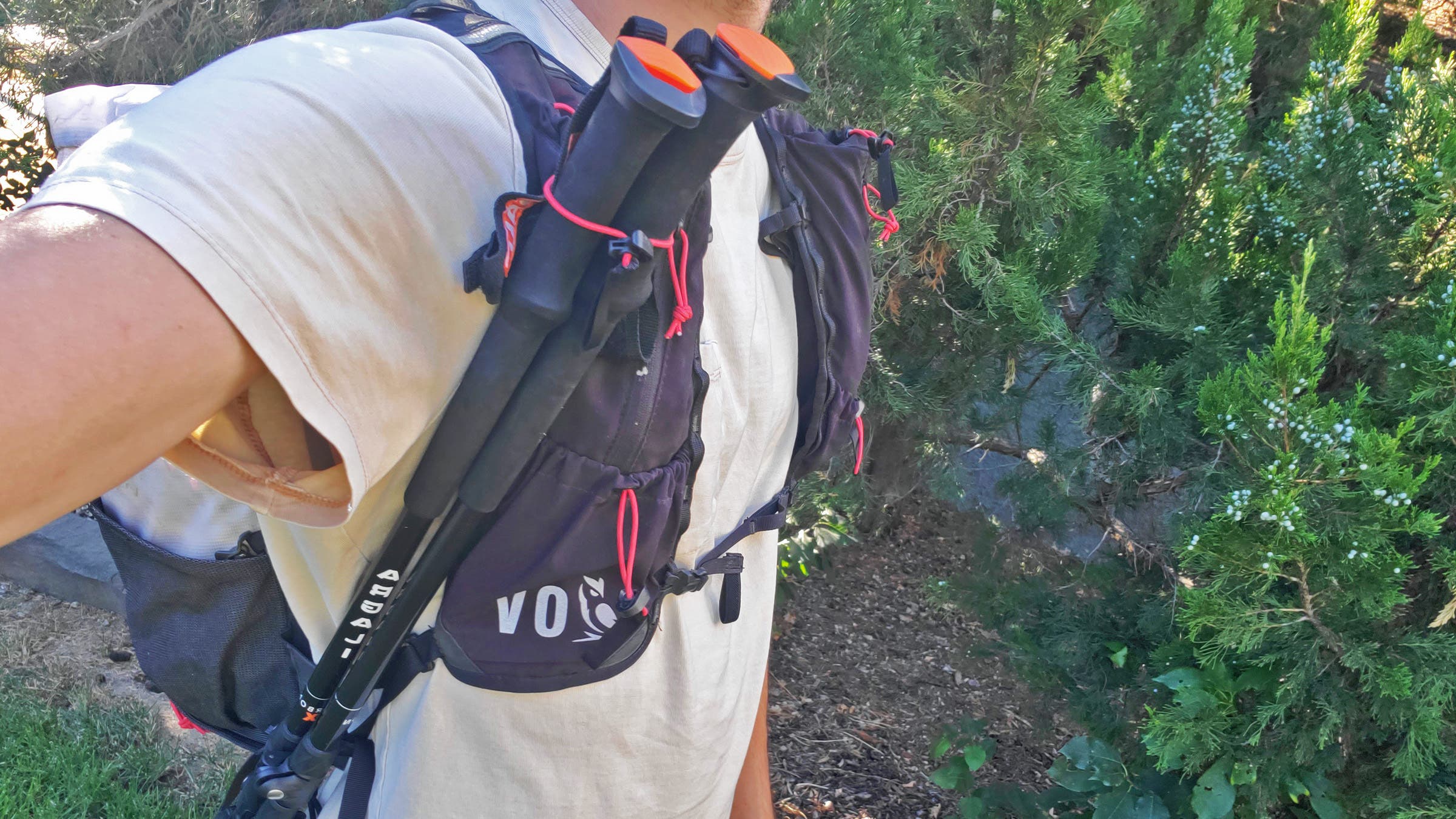 DIY trekking pole bungee cord setup on backpack with shock cord and cord locks