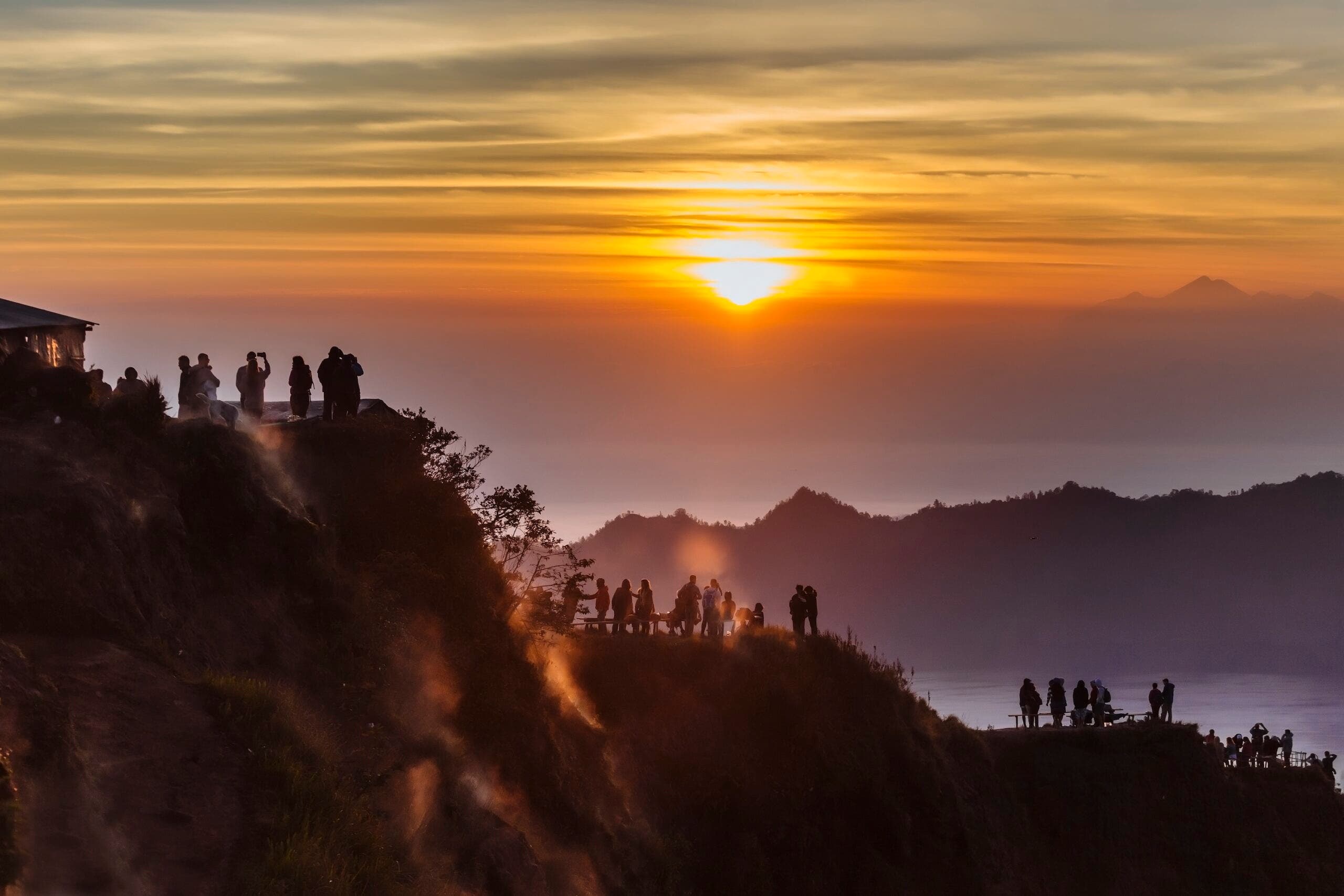 Silhouettes of people at sunset, Mount Batur, Bali, Indonesia