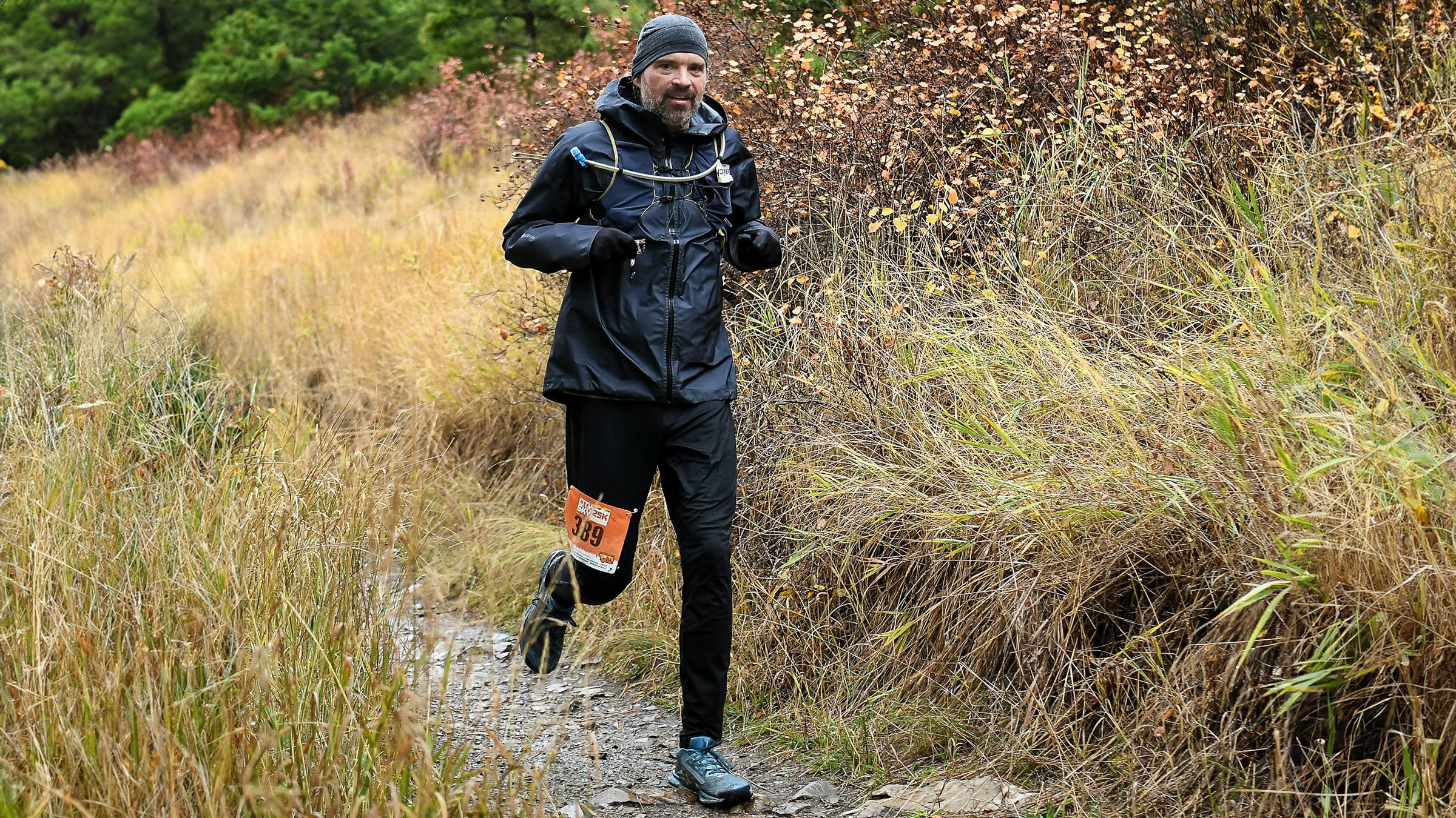 Trail runner jogging in 7mesh Guardian Air shell