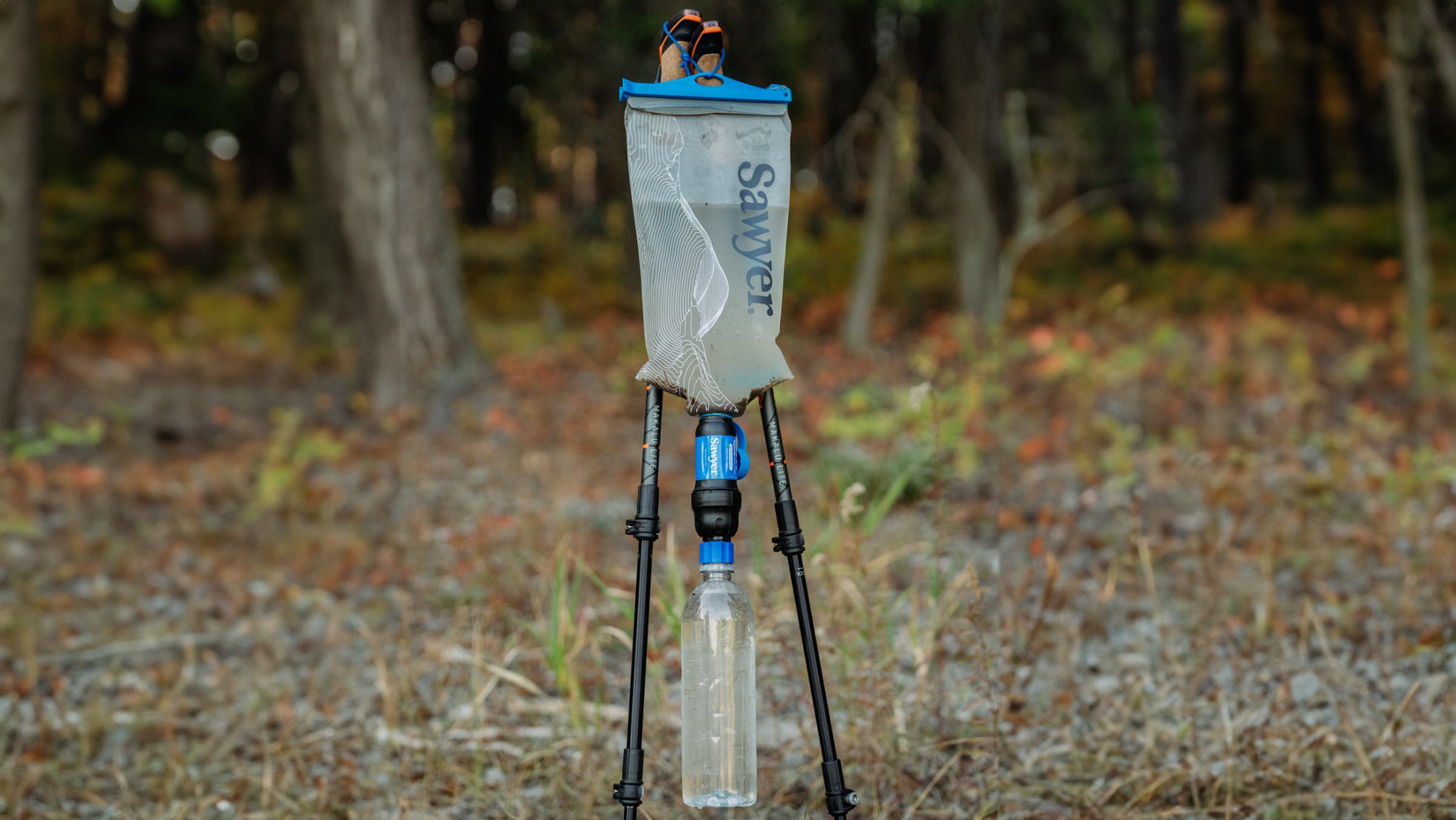 Sawyer Squeeze Water Filtration System being used as a gravity filter on trekking poles in the backcountry.