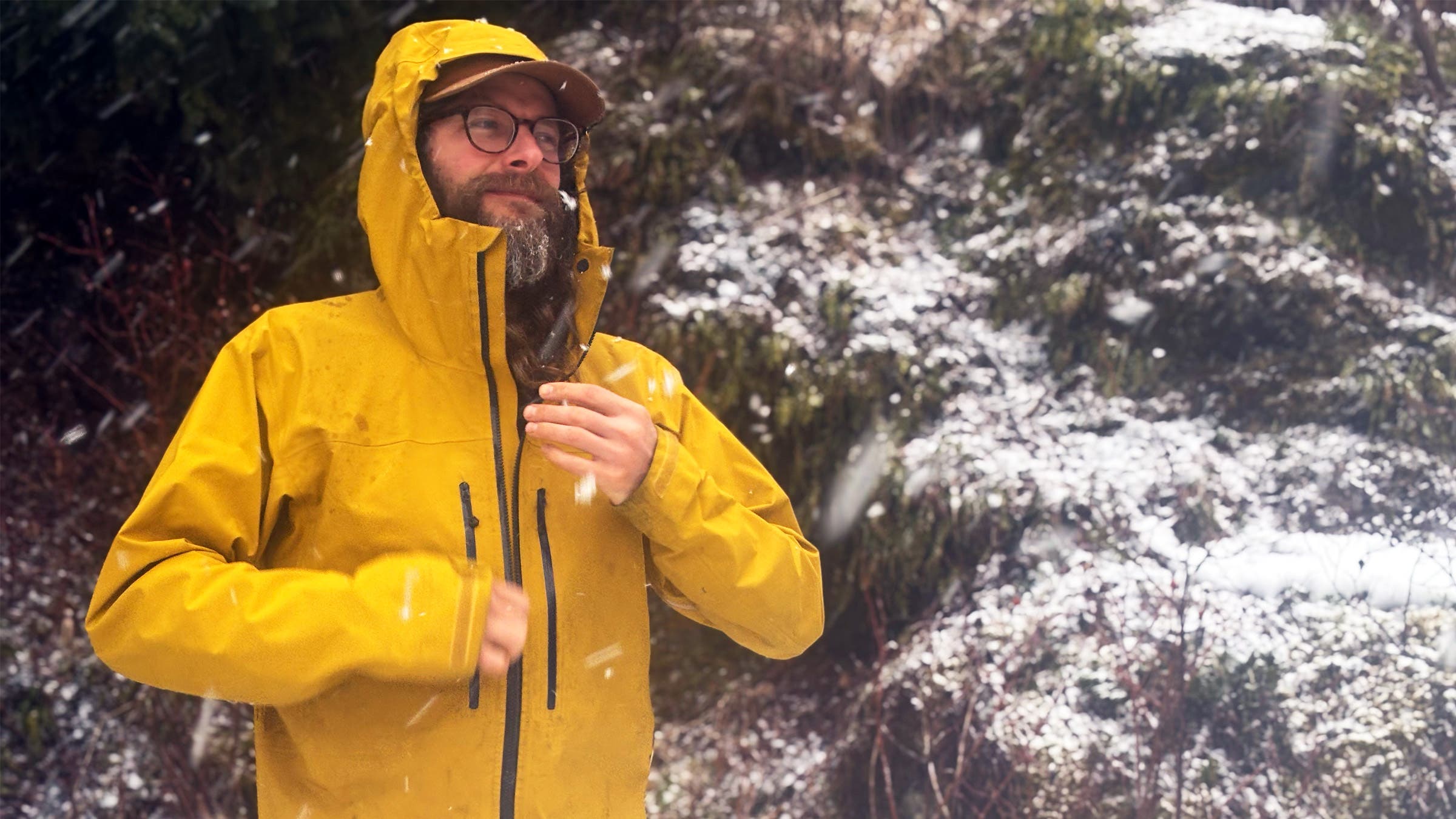 Tester zipping up and using hood of Montane Alta XT shell