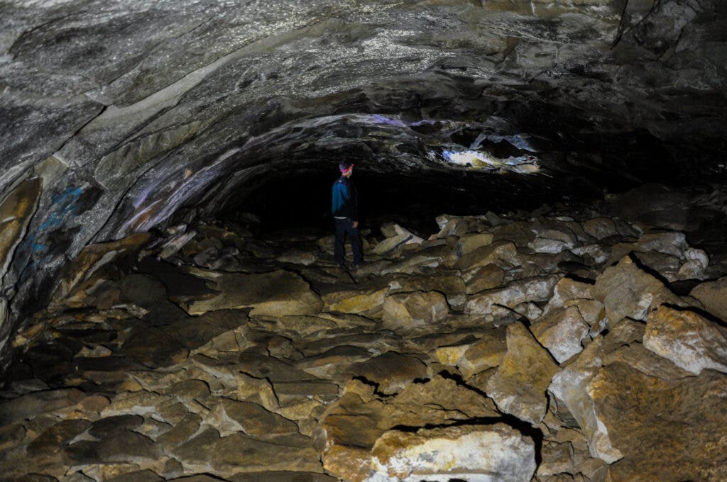 A person standing in Coconino Lava River Cave