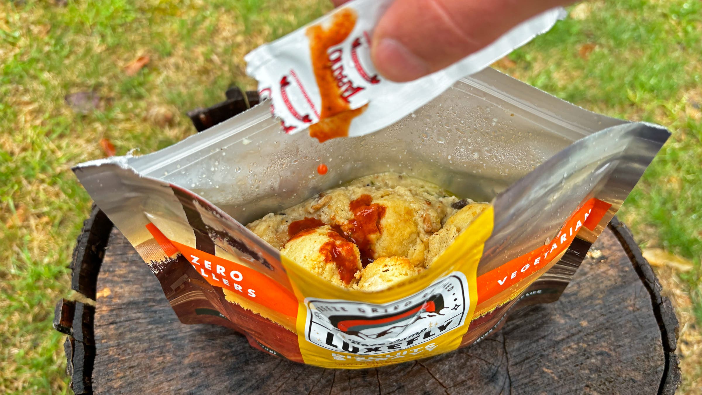 Drizzle hot sauce into a backpacking meal of biscuits and gravy
