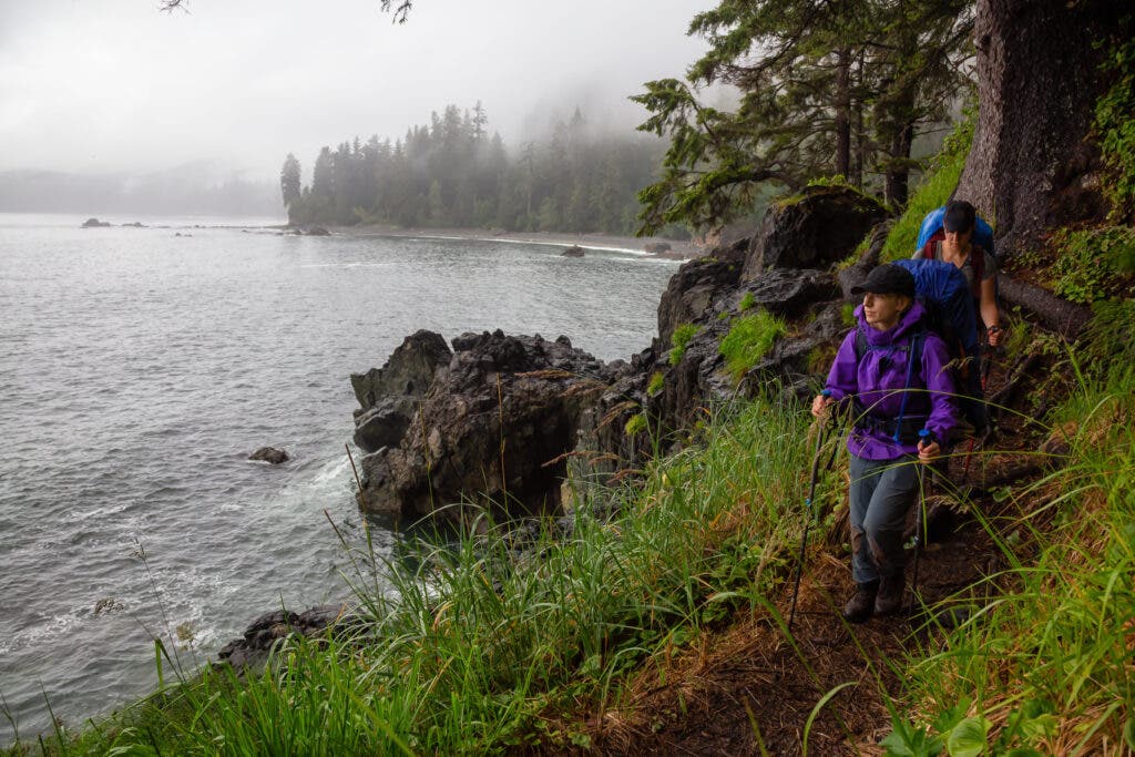 Two backpackers on the Juan de Fuca Trail looking towards the ocean