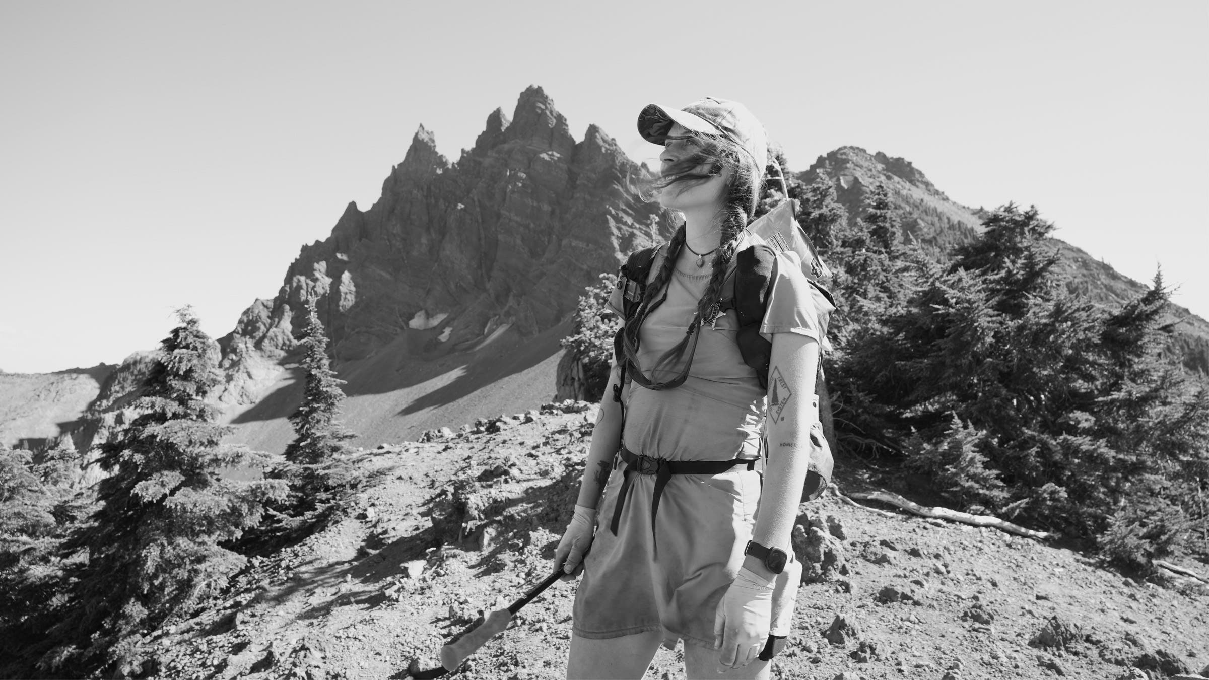 A hiker in front of mountains