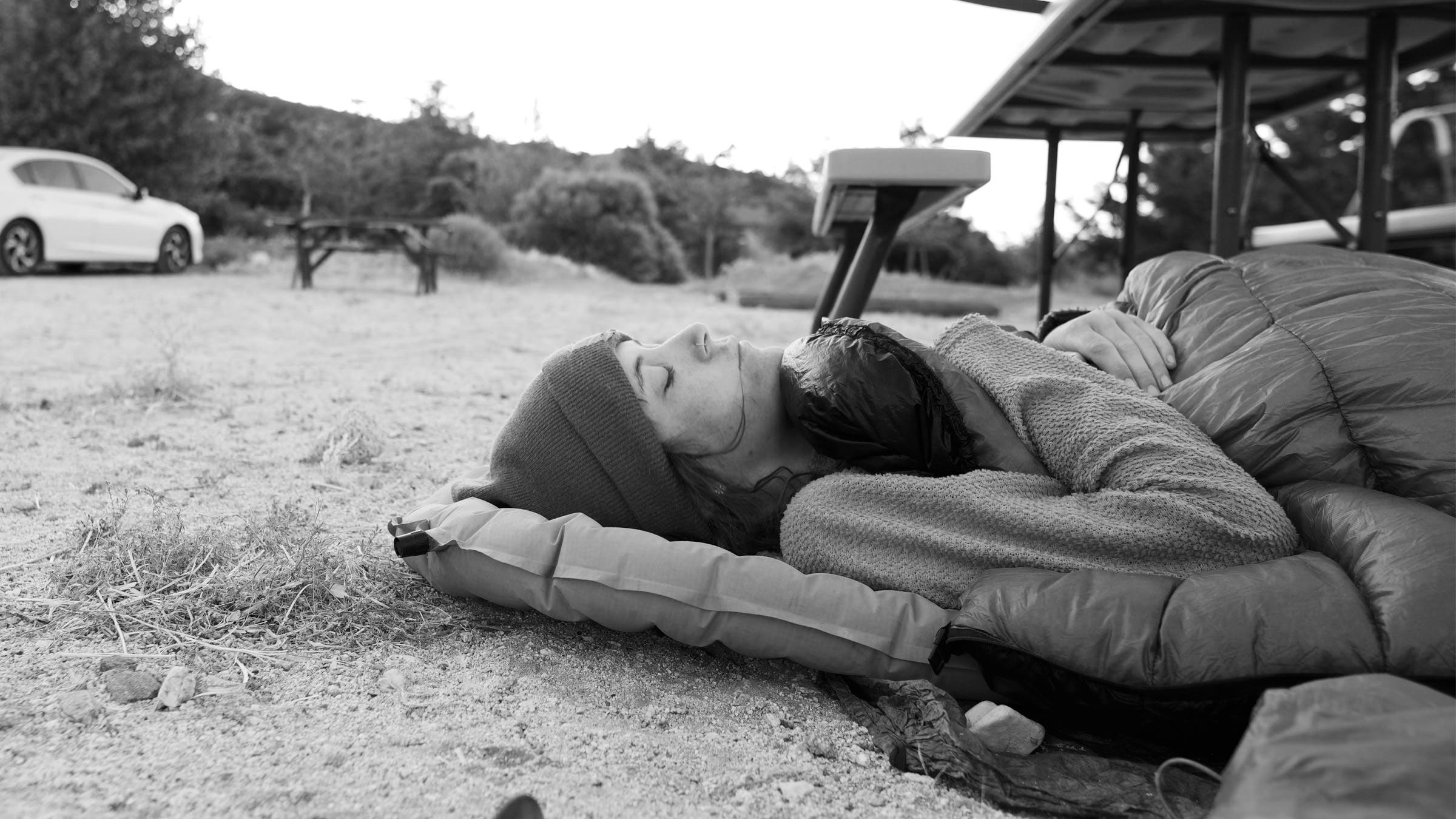 A hiker sleeping on a pad